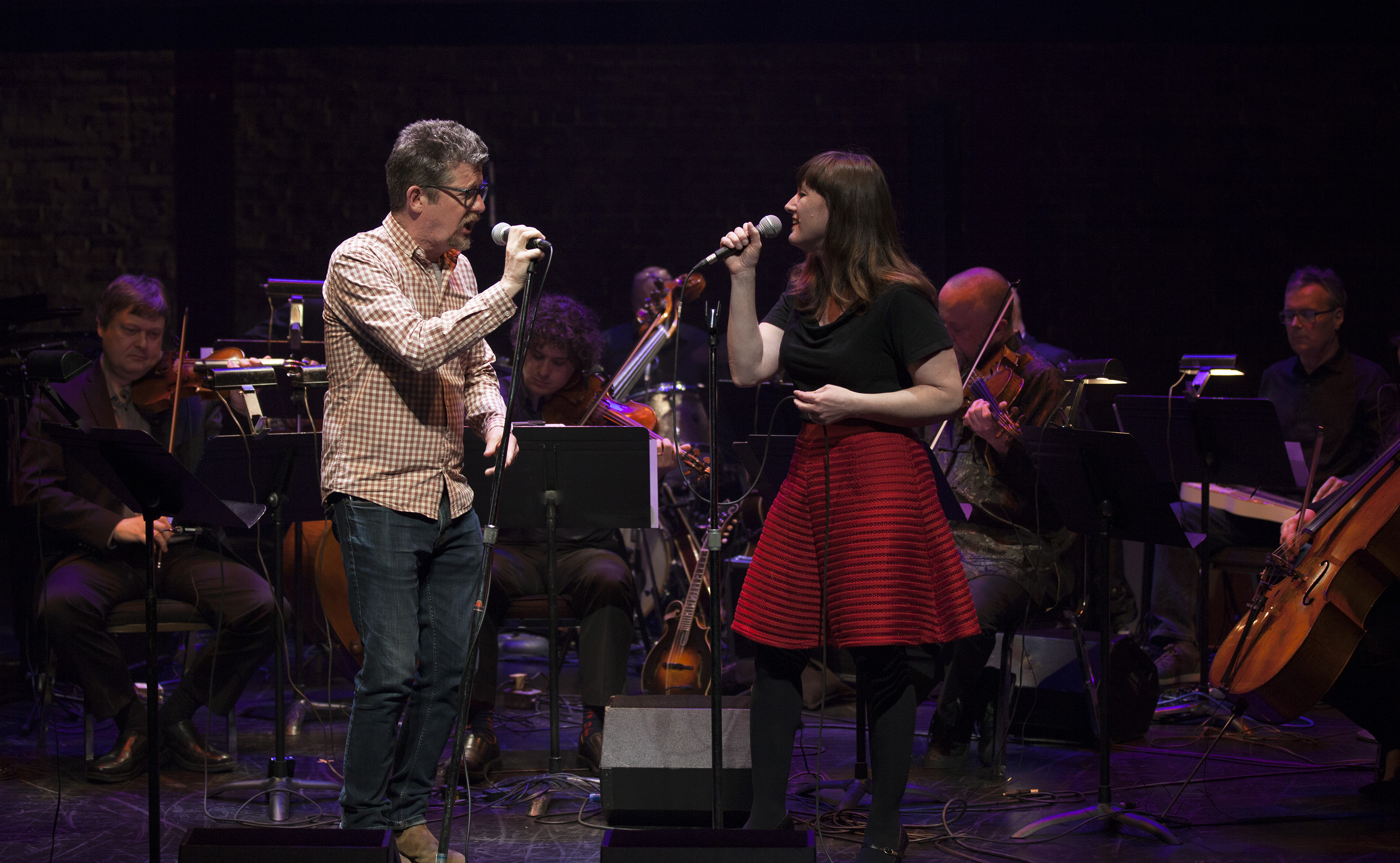 Singers Andy Maize and Suzie Ungerlieder sing in Art of Time Ensemble’s Doghouse Roses: The Words and Music of Steve Earle.